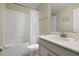 Clean bathroom with a shower/tub combo and gray vanity at 8911 Stinger Dr, Champions Gate, FL 33896