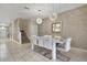 Elegant dining room with a white table and chairs, and contemporary light fixtures at 8911 Stinger Dr, Champions Gate, FL 33896