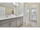 Double vanity bathroom with a view to the outside at 8911 Stinger Dr, Champions Gate, FL 33896