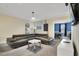 Relaxing living room with a sectional sofa and a game room view at 8911 Stinger Dr, Champions Gate, FL 33896