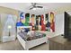 ' bedroom with superhero-themed wall and twin bed at 8911 Stinger Dr, Champions Gate, FL 33896