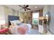 Stylish bedroom with a gray headboard, pink knit blanket, and striped walls at 1400 Arklow Cir, Ormond Beach, FL 32174