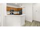 Modern kitchen with stainless steel appliances and light wood cabinets at 6119 Metrowest Blvd # 106, Orlando, FL 32835