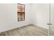 Simple bedroom with hardwood floors and large window at 6119 Metrowest Blvd # 106, Orlando, FL 32835