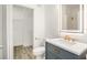 Modern bathroom with a gray vanity, marble countertop, and a walk-in closet at 6119 Metrowest Blvd # 106, Orlando, FL 32835