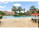 Resort-style pool with ample lounge chairs and tables at 6119 Metrowest Blvd # 106, Orlando, FL 32835
