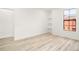 Spacious bedroom featuring wood-look floors and a large window at 6119 Metrowest Blvd # 106, Orlando, FL 32835