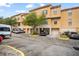 Exterior view of townhouses with parking and lush landscaping at 6119 Metrowest Blvd # 106, Orlando, FL 32835