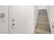 Interior entryway with white door and wood-look stairs at 6119 Metrowest Blvd # 106, Orlando, FL 32835