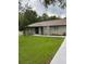 Newly renovated home with gray exterior, modern landscaping, and a welcoming front entrance at 19 Pine Court Loop, Ocala, FL 34472