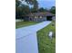 Newly renovated home with a long driveway and beautifully landscaped front yard at 19 Pine Court Loop, Ocala, FL 34472