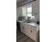 Clean kitchen with white cabinets, marble countertops, and a double sink at 19 Pine Court Loop, Ocala, FL 34472