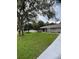 Newly renovated home with gray exterior, modern landscaping, and a welcoming front entrance at 19 Pine Court Loop, Ocala, FL 34472