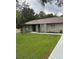 Newly renovated home with gray exterior, modern landscaping, and a welcoming front entrance at 19 Pine Court Loop, Ocala, FL 34472