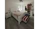 Spacious primary bedroom with a king-size bed, nightstands, and a decorative bench at 19 Pine Court Loop, Ocala, FL 34472