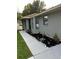 Landscaped walkway leading to the front entrance of a home with solar-powered path lights at 19 Pine Court Loop, Ocala, FL 34472