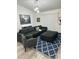Spacious living room featuring a sectional sofa, ottoman, and blue patterned rug at 19 Pine Court Loop, Ocala, FL 34472