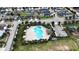 Aerial view of community pool with playground and surrounding homes at 1080 Condor Dr, Haines City, FL 33844