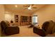Living room with two recliners, coffee table, and a large TV at 1080 Condor Dr, Haines City, FL 33844