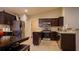 Kitchen with dark wood cabinets and stainless steel appliances at 1080 Condor Dr, Haines City, FL 33844