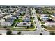 Aerial view of houses in a residential neighborhood, showing street layout and landscaping at 1080 Condor Dr, Haines City, FL 33844