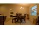 Dining area with a table and bench seating, overlooking the bedroom at 1080 Condor Dr, Haines City, FL 33844