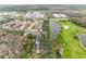 Aerial view of a community with houses, golf course, and lake at 1008 Waterside Dr, Celebration, FL 34747