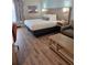 Hotel bedroom with king-size bed, sitting area, and wood-look floors at 3000 Maingate Ln # 522, Kissimmee, FL 34747