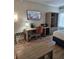 Hotel room workspace with desk, chair, TV, and mini-fridge at 3000 Maingate Ln # 522, Kissimmee, FL 34747