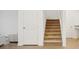 Carpeted staircase with white trim and wood-look floors at 4949 Olivia Ct, St Cloud, FL 34772