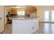 Modern kitchen with light wood cabinets, stainless steel appliances and curved breakfast bar at 9076 Sw 95Th Ave # 9076, Ocala, FL 34481