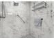 Large walk-in shower with marble tile and grab bars at 9076 Sw 95Th Ave # 9076, Ocala, FL 34481