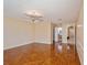 Bright bedroom with wood-look tile floors, ceiling fan, and access to bathroom at 9076 Sw 95Th Ave # 9076, Ocala, FL 34481