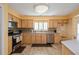 Well-equipped kitchen with light wood cabinets, stainless steel appliances and tile flooring at 9076 Sw 95Th Ave # 9076, Ocala, FL 34481