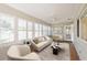 Sunroom with tiled floor, white shutters, and comfy seating at 9076 Sw 95Th Ave # 9076, Ocala, FL 34481