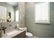 Elegant powder room with modern fixtures and green wall at 4162 Grande Brick Loop # 27, Orlando, FL 32837