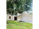 Two-story house with a three car garage and large tree at 1856 Emily Dr, Winter Haven, FL 33884