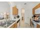 Cozy kitchen with double sink, wood cabinets, and electric stove at 13524 Turtle Marsh Loop # 638, Orlando, FL 32837