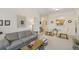 Open living and dining area with grey couch and glass-top coffee table at 13524 Turtle Marsh Loop # 638, Orlando, FL 32837