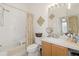 Clean bathroom boasts a shower/tub combo, updated vanity, and decorative accents at 13524 Turtle Marsh Loop # 638, Orlando, FL 32837