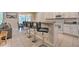 Modern kitchen with granite countertops, white cabinets, and breakfast bar with seating at 742 Orange Cosmos Blvd, Davenport, FL 33837
