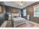 Cozy bedroom with a queen bed, dark walls, and plenty of natural light at 742 Orange Cosmos Blvd, Davenport, FL 33837