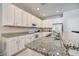Modern kitchen with white cabinets and granite countertops at 742 Orange Cosmos Blvd, Davenport, FL 33837