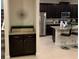 Modern kitchen with dark cabinetry, stainless steel appliances, and an island at 7405 Marker Ave, Kissimmee, FL 34747