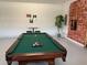 Game room with pool table and brick accent wall at 7405 Marker Ave, Kissimmee, FL 34747