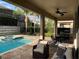 Covered patio with comfortable seating overlooking the pool at 7405 Marker Ave, Kissimmee, FL 34747