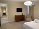 Bedroom with dresser, TV, and sitting area at 7405 Marker Ave, Kissimmee, FL 34747