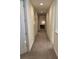 Long hallway with carpeted floor and doors to rooms at 7405 Marker Ave, Kissimmee, FL 34747