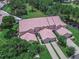 Aerial view of a community of tan townhouses with red tile roofs at 28 Golf Villa Dr, Port Orange, FL 32128