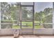 Private screened porch with a view of the community’s landscaping at 28 Golf Villa Dr, Port Orange, FL 32128